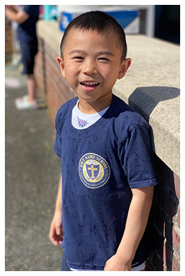 Elementary boy smiling while outside at recess