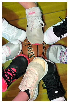 Close-up of student shoes around a basketball