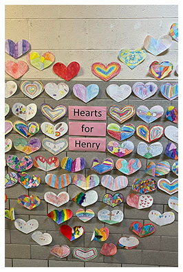 Wall filled with paper hearts for Henry