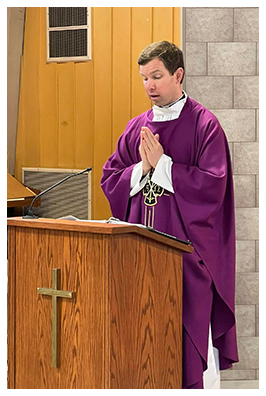 Pastor in purple robe leading prayer