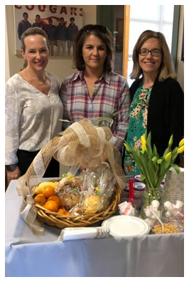 Three women and a gift basket
